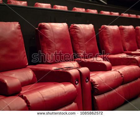 recliner-movie-theater-seats-in-a-luxury-movie-theater-1085862572.jpg